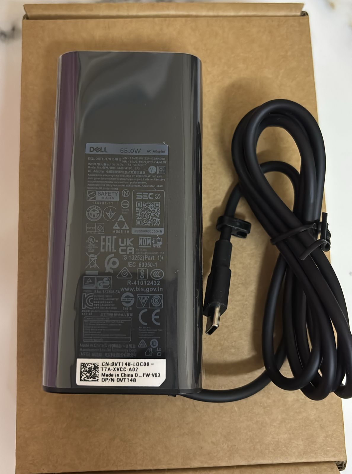 DP/N 0VT148 is a genuine Dell part number for a 65W USB-C AC adapter. Multiple parts databases identify 0VT148 / VT148 as a Dell OEM part.